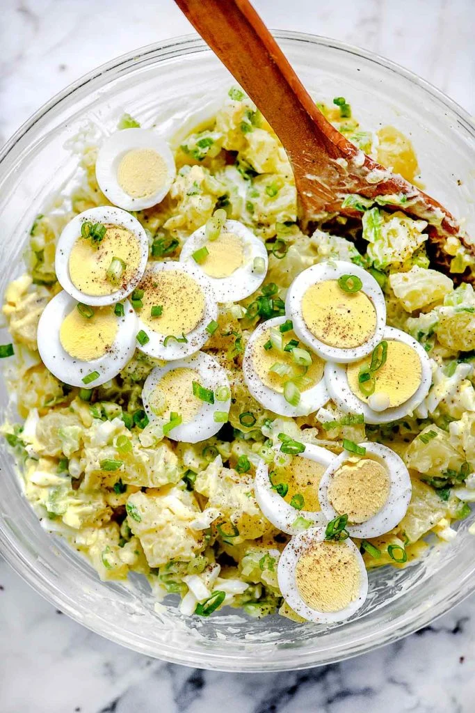 Slice the remaining egg and arrange it on top of the salad, then sprinkle lightly with paprika if desired