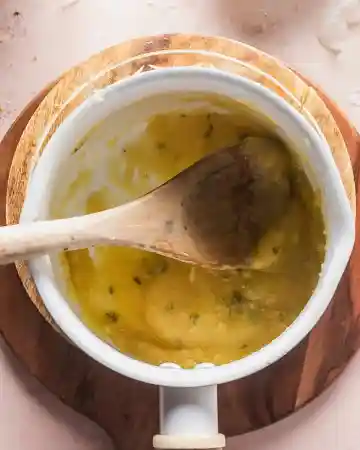 Slowly pour in the cream while whisking, allowing the mixture to smooth out and thicken into a rich sauce