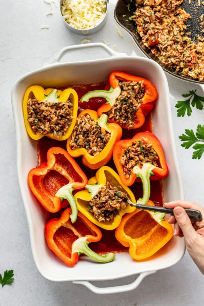 Spoon the filling evenly into each pepper half, making sure they are filled generously without overflowing
