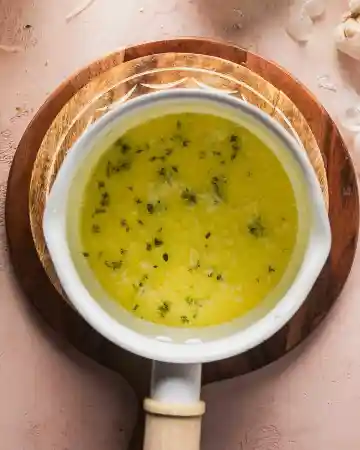 Start by melting butter in a saucepan over medium-low heat, then add thyme and garlic and cook gently until fragrant