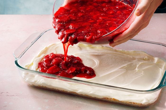 Carefully spoon the partially set gelatin mixture over the chilled cream layer, spreading it evenly. Return the dish to the refrigerator and chill for several hours until the top layer is fully set.