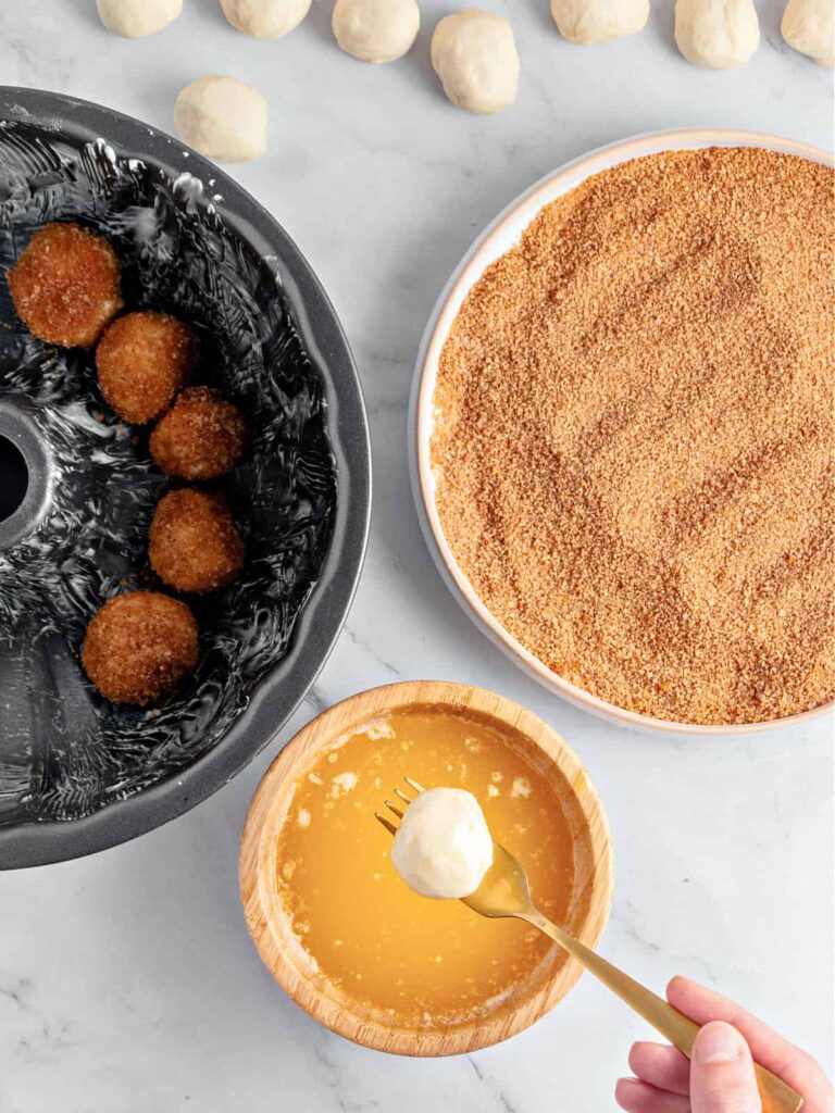 Place melted butter in one bowl and mix brown sugar with cinnamon in another. Dip each dough ball into butter, then coat in the sugar mixture.