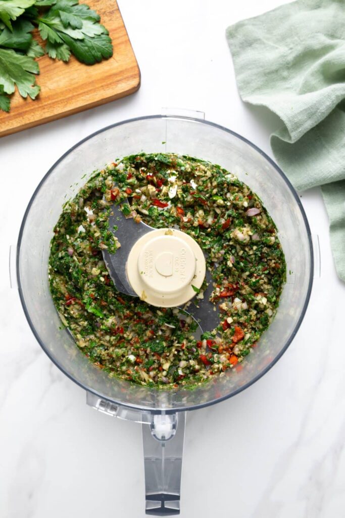 Add the chopped parsley, garlic, oregano, red wine vinegar, diced chile (or red pepper flakes), salt, and black pepper to a medium bowl. Mix everything together until evenly combined.