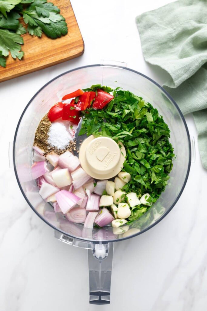 Start by finely chopping the parsley and mincing the garlic and shallot if using. Aim for small, even pieces so the sauce has a balanced texture.