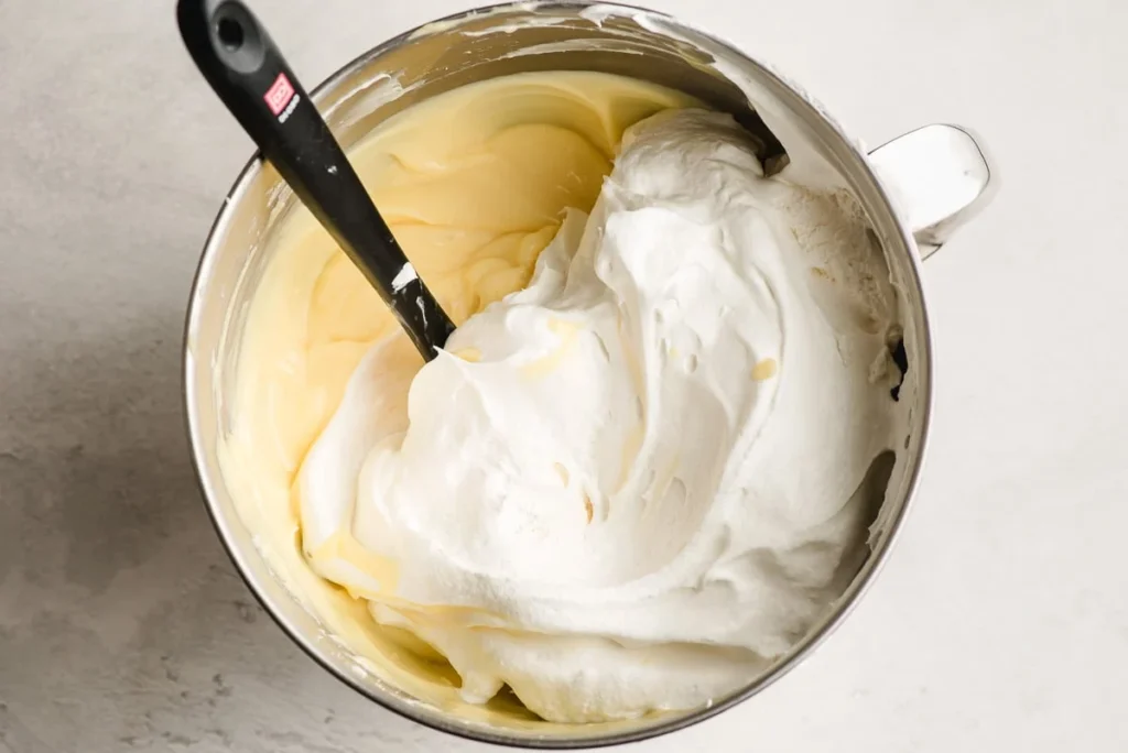 In a bowl, whisk together the milk and pudding mix until it begins to thicken, then set aside.