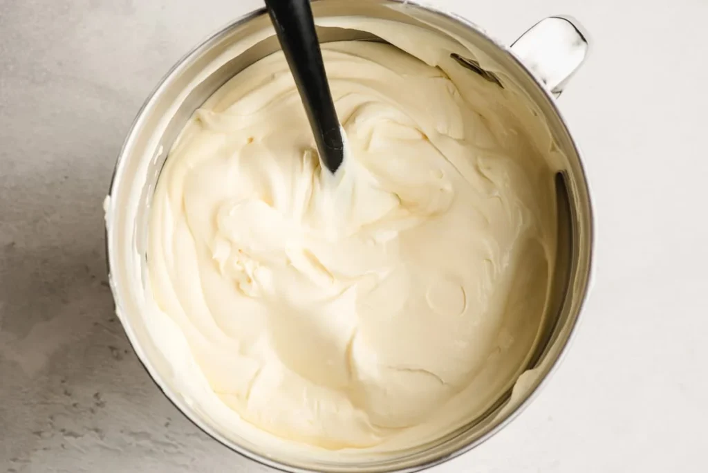 Add the prepared pudding to the cream cheese mixture and mix until fully combined. Gently fold in the whipped topping until light and creamy.