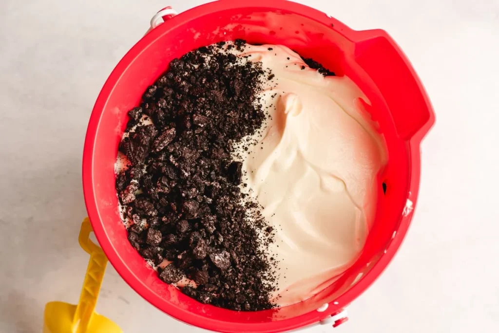 In your serving dish, spread a layer of pudding mixture at the bottom, followed by a layer of the Oreo mixture. Continue layering until everything is used, finishing with a layer of Oreos on top.