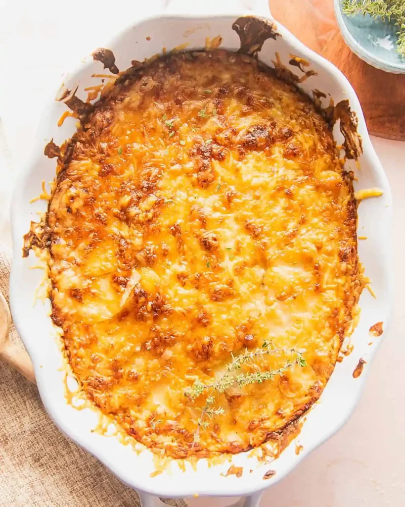 Cover the dish with foil and bake in a preheated oven at 350°F until the potatoes are tender. Remove the foil and continue baking until the top turns golden brown and bubbly. Allow the dish to rest briefly before serving so the sauce can settle and thicken.