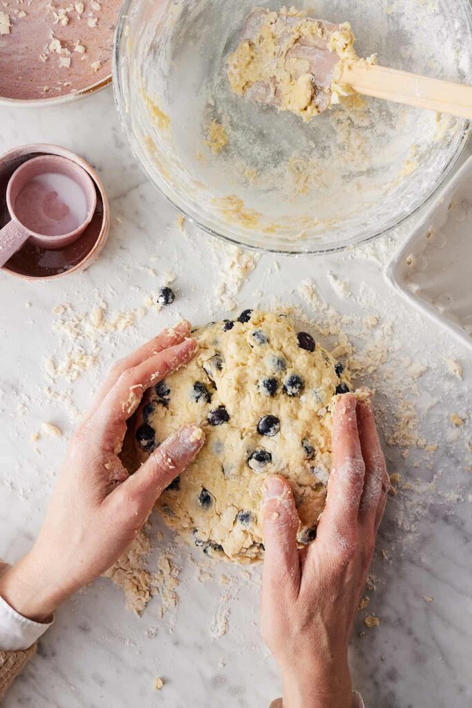 Transfer the dough onto a lightly floured surface and shape it into a round disk about one inch thick. Cut into eight equal wedges and place them onto the prepared baking sheet, leaving a bit of space between each piece.